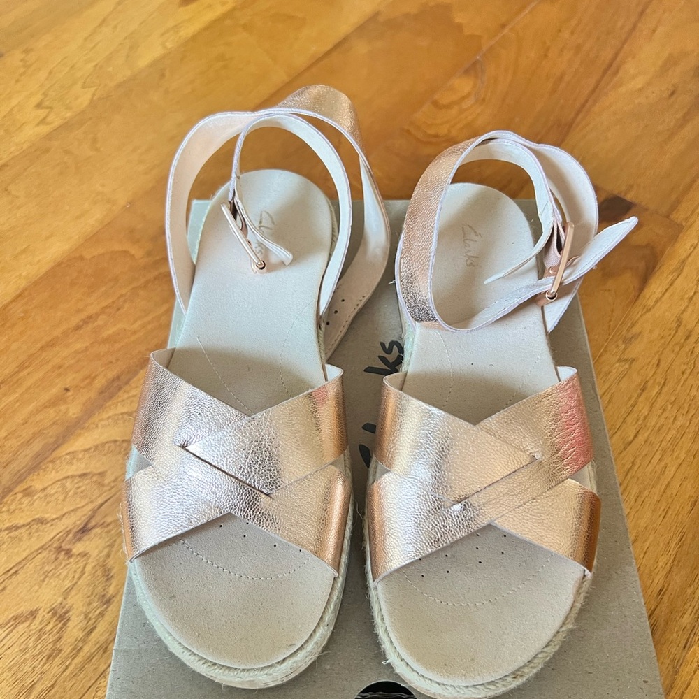 Clarks womens Botanic Poppy metallic espadrille sandals in a rose gold color.